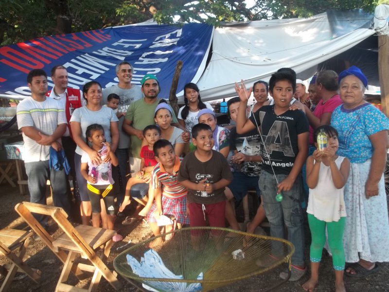 Wilbur's family standing outside temporary shelter